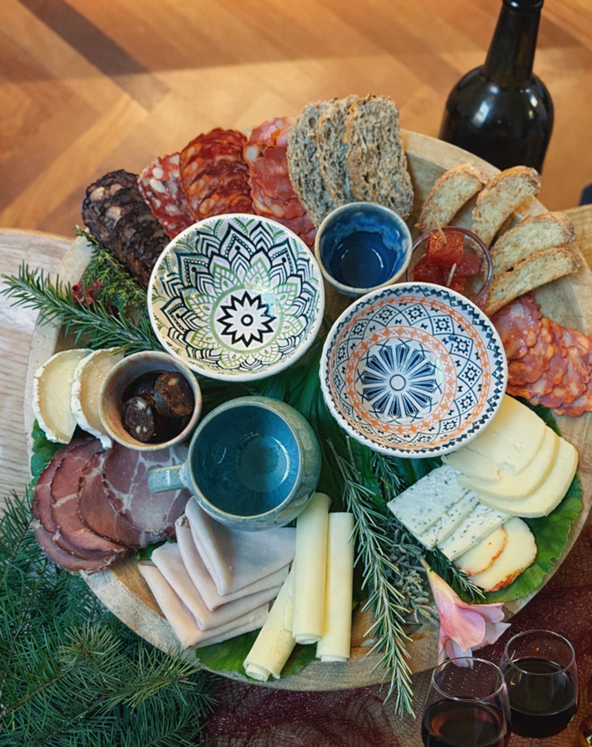Local Tasting Selection of cheeses, bread, and accompaniments arranged on table
