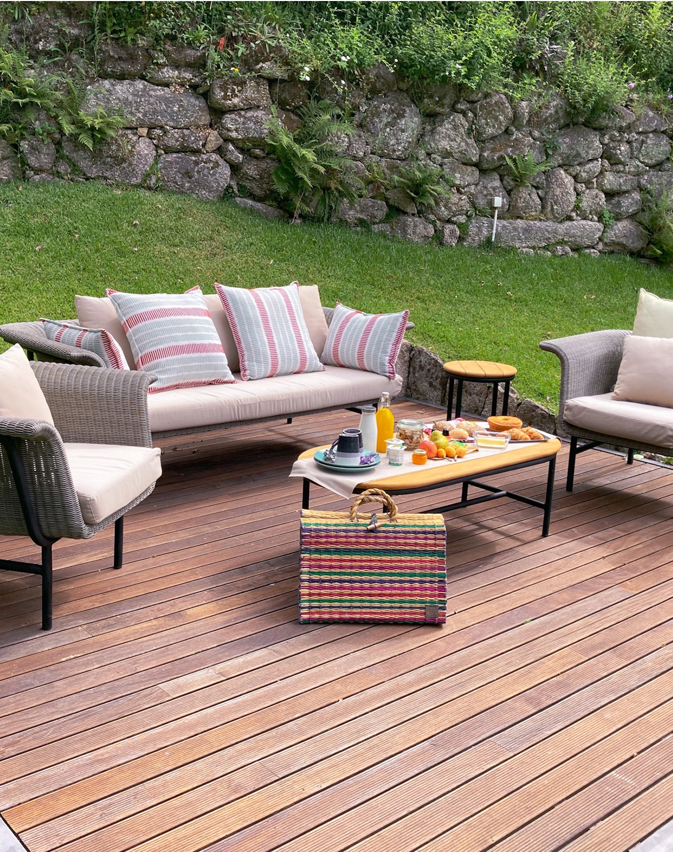 Sofa and table on wooden deck with cushions