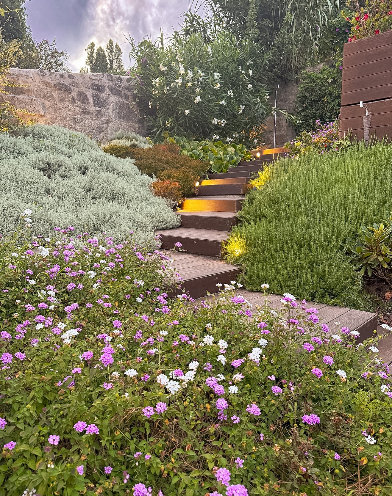 Garden Path Stone steps through garden with flowers and greenery