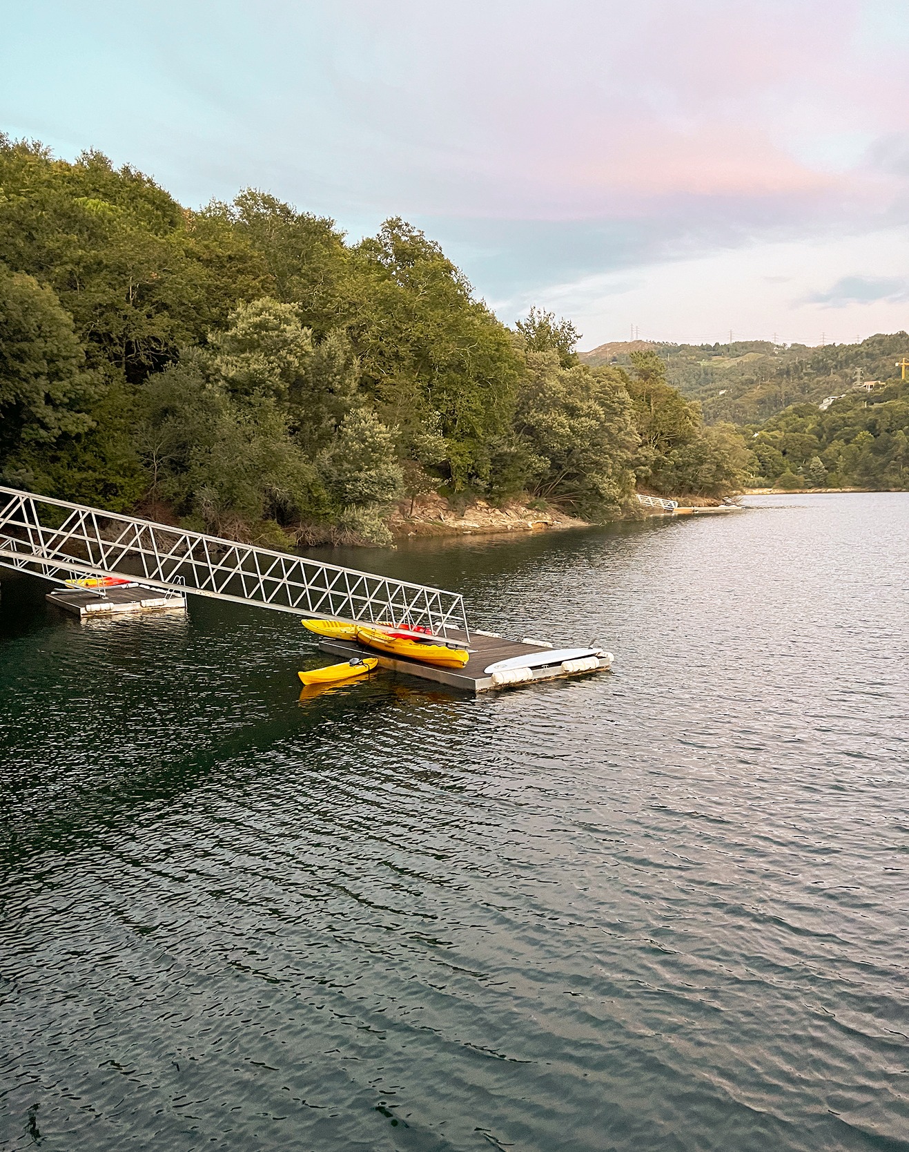 Floating pier connected to the shore extending into the lake at Runas Carqueijais in Gerês